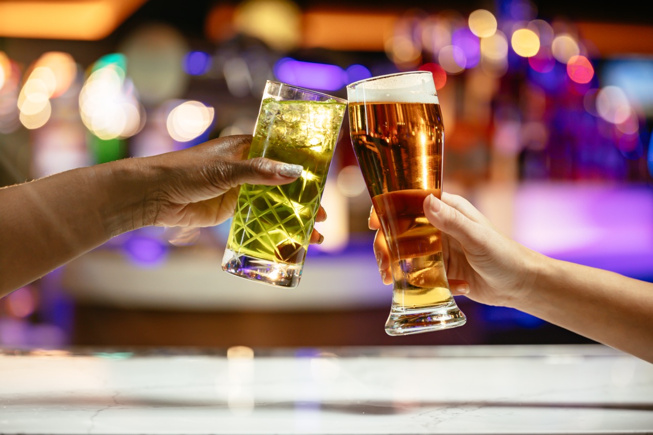 Drink service interaction between bartender and guest at Starting Gate Sportsbook